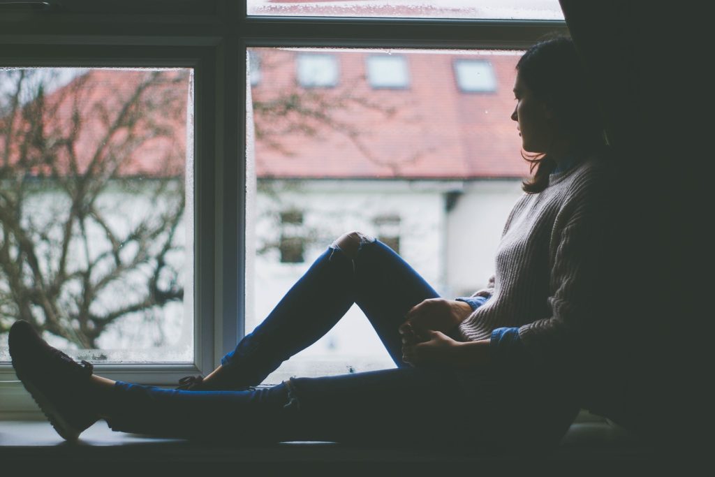 Girl looking out window