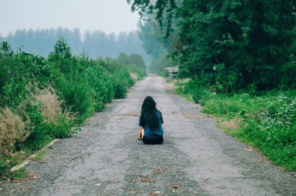 woman sitting in road