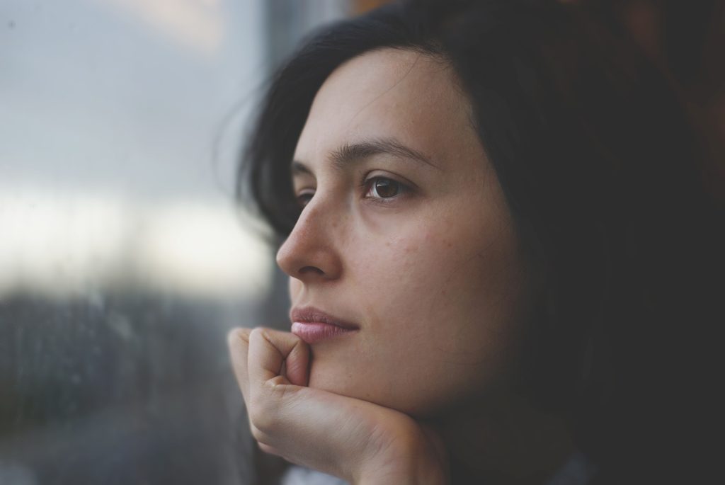 woman staring out window